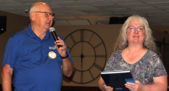 President Greg McCune presented a District award Lisa Brummett for her leadership in the Optimist District Essay Contest.