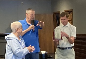 Rod and Susan Obermeier presented Tom Hintz with a plaque thanking him for all the things he did as governor when he was governor.